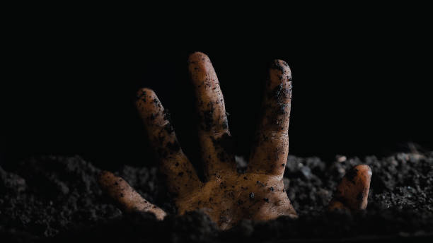 istock A single, dirt-covered hand emerges from the soil, suggesting a struggle or symbolic unearthing 2159601500