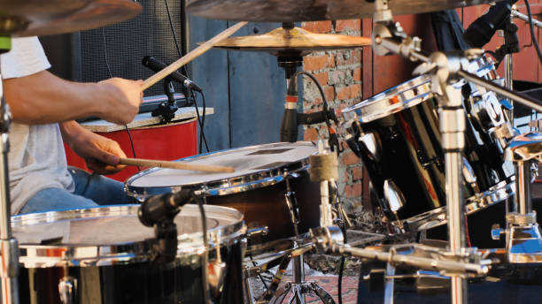 istock A passionate musician is immersed in playing drums at a live event 2159601545
