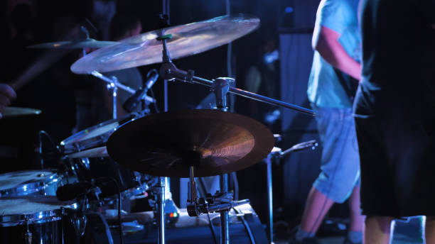 istock A live musical event, centered around a drum kit illuminated by cool blue concert lights 2159601565
