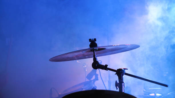 istock A drum set takes center stage, bathed in blue lights, ready 2159601577