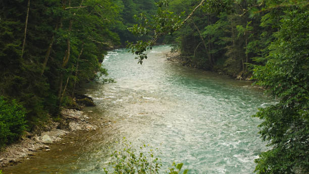 istock View of a winding mountain river bed with a fast, strong current 2159601670