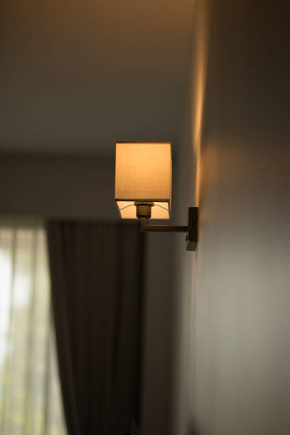 istock A sconce emits a warm glow, enhancing ambiance. 2159602953