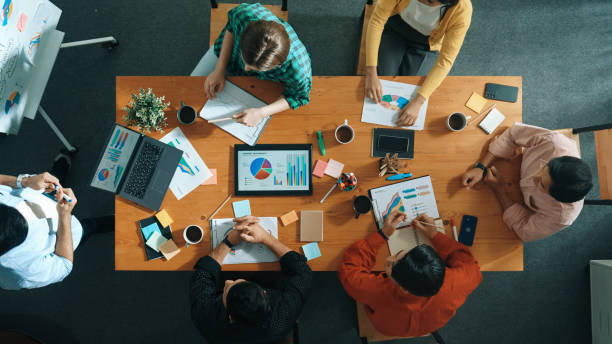 istock Top view of business people sharing idea about startup project. Convocation. 2159603650
