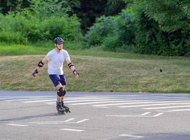 New York, NY, USA - June 26, 2024 - Man roller blades in Central Park on a very hot June late afternoon. The park is pretty empty as most people seem to be keeping cool inside.