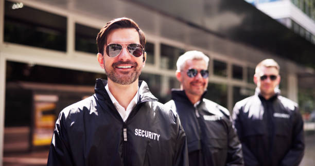istock Professional Security Guard Ensuring Event Safety with His Close-knit Group 2159608076