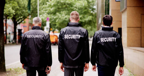 istock Caucasian Security Officer in Uniform Leading Group of Event Staff 2159608091