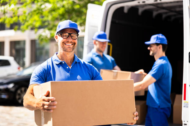 istock Efficient delivery men in blue uniforms are moving appliances into a truck 2159608113