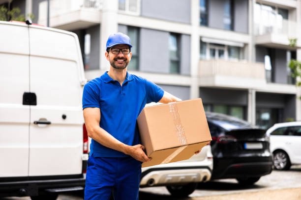 istock Smiling Delivery Man Moving Boxes by Van, Showing Expertise in Logistics 2159608126