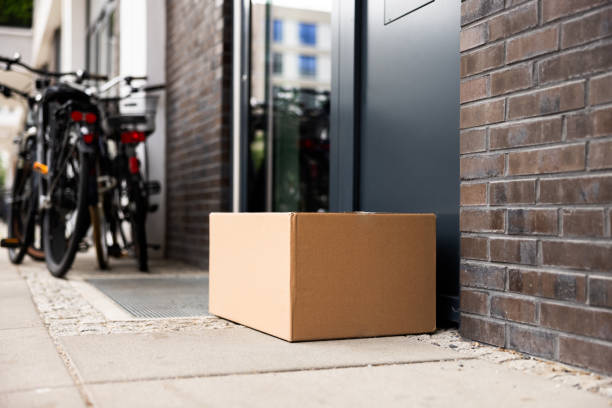 istock Courier Delivering Packages Safely to Front Doors of Homes, Ensuring Security 2159608137