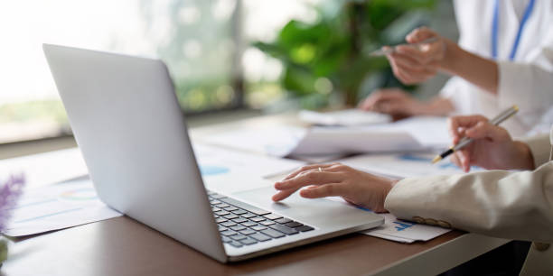 istock Business Teamwork Planning and Analysis Discussion with Laptop and Documents in Modern Office Setting 2159611065