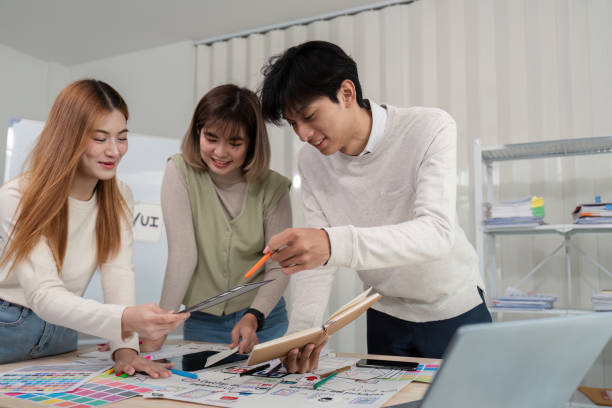 istock Creative UX Developer and UI Designer Team Brainstorming Innovative Ideas in Modern Office Environment 2159612357