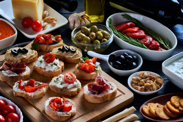 Appetizers and tapas themes: High angle view of an assortment of Mediterranean appetizers or tapas on a cutting board