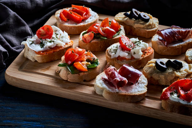 istock Assortment of Mediterranean appetizers or tapas on a cutting board 2159612452