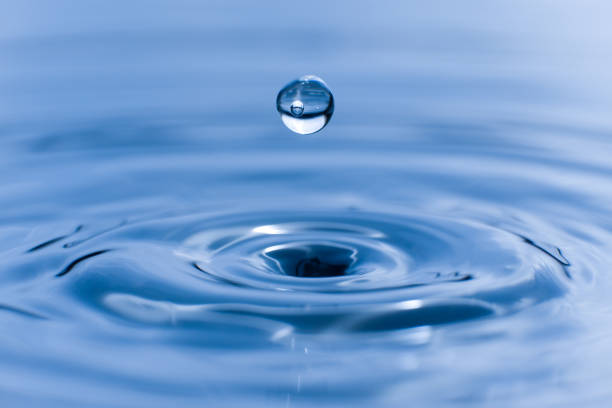 istock blue drop water , Liquid blue  water drop ripple background 2159612755