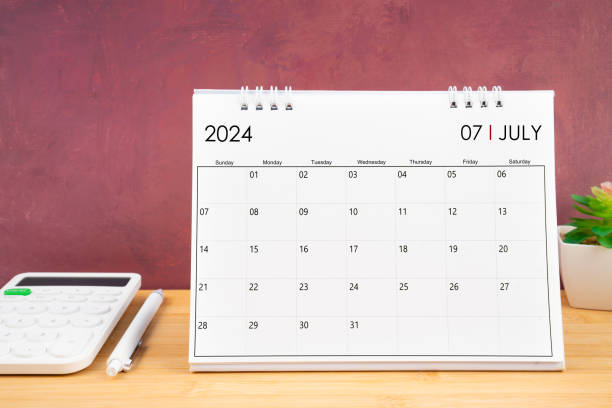 istock July 2024 white calendar and calculator with pen. 2159614557