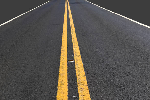 gray mockup and asphalt roadway with two yellow lines and markers painted on the ground, in Brazil