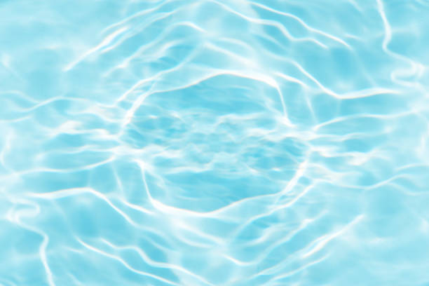 istock Blue water with ripples on the surface. Defocus blurred transparent blue colored clear calm water surface texture with splashes and bubbles. Water waves with shining pattern texture background. 2159618289