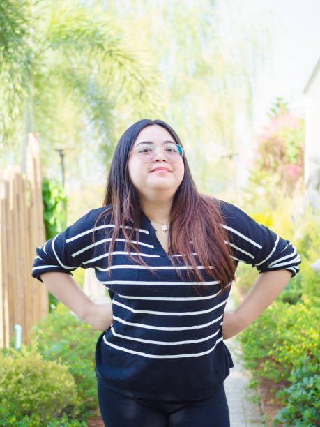 istock Young chubby Asian woman is confident and smiling looking at camera. 2159619094