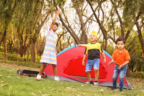 Group Of Boys Having Fun In Tent In Countryside