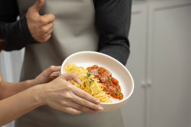 istock Close up hand couple chef influencers completely cooked spaghetti. Postulate. 2159620475
