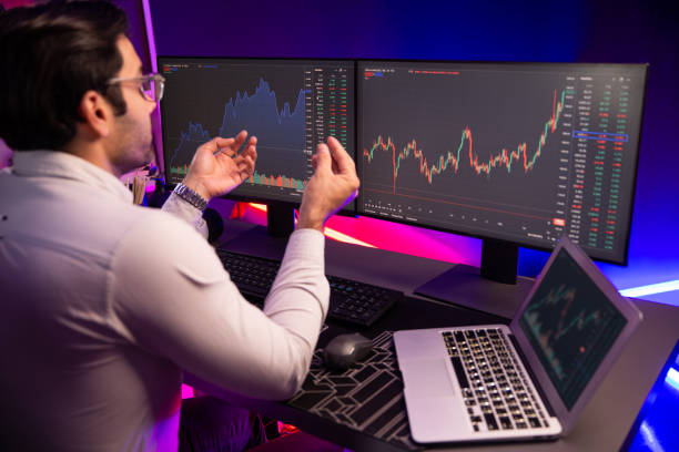istock Smart trader concentrating on dynamic stock exchange on pc and laptop. Surmise. 2159621032