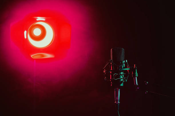 Professional microphone in red smoke on a black background
