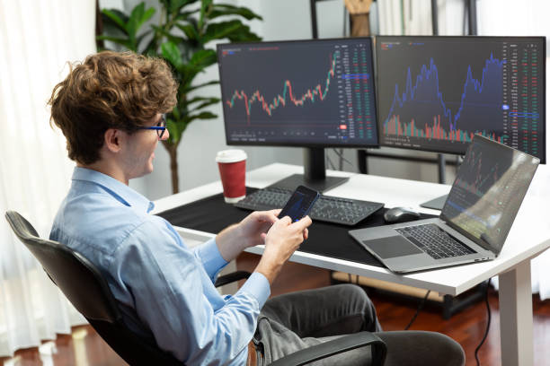 istock Business trader focusing smartphone comparing with laptop at office. Gusher. 2159621409
