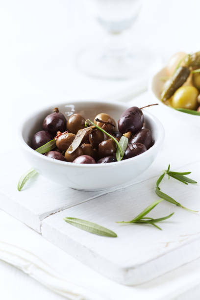 istock Various olives on white wooden background. Close up. Copy space. 2159622587