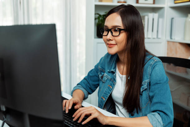 istock Working asian manager with glasses typing to search on pc. Stratagem. 2159626092