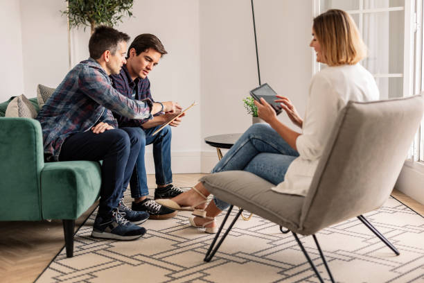 istock Group Discussion with Digital Devices in a Modern Living Room 2159627344