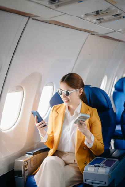 istock Asian Woman Working on Tablet During  in first class, multitasking with Flight Travel in style, work 2159628681