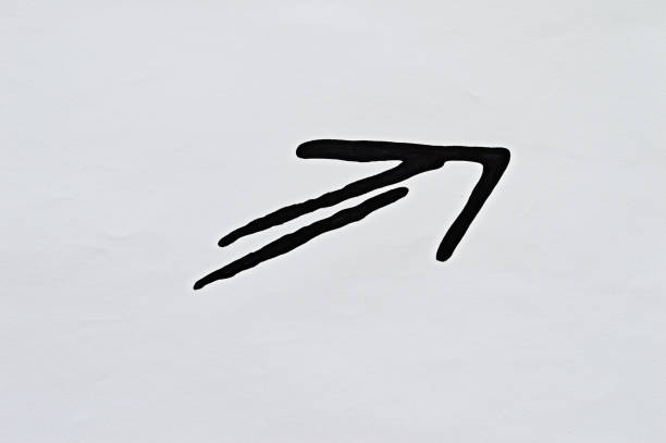Black arrow drawn with marker on white paper.