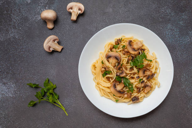 istock Mushroom Spaghetti Pasta and cream sauce on rustic, dark background, top view, copy space. Homemade italian pasta with champignon mushroom. 2159631540