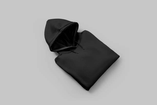 istock Mockup of black oversized hoodie, folded, diagonal presentation on white background with shadows, stylish men's clothing, front view. 2159631944