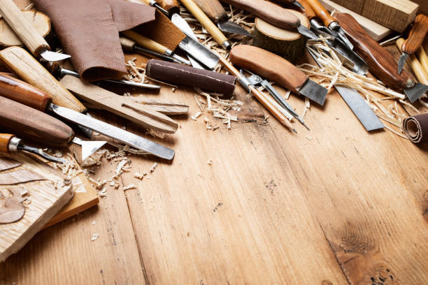 istock Carving tools in carpentry workshop desk on wooden table. 2159632541