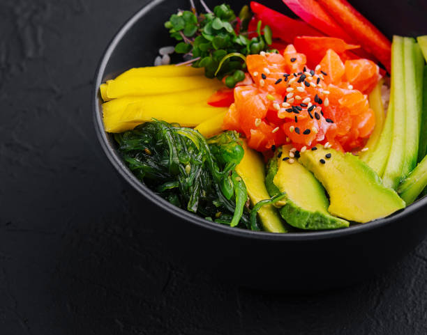 istock Fresh salmon poke bowl on dark background 2159633844