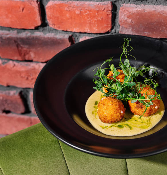 istock Gourmet fried balls on elegant black plate 2159633987