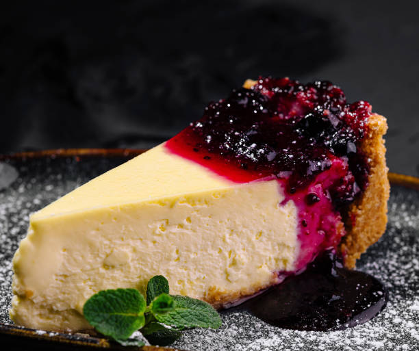 istock Gourmet cheesecake with berry compote on dark background 2159634709
