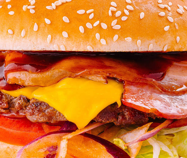 Delicious bacon cheeseburger close up background