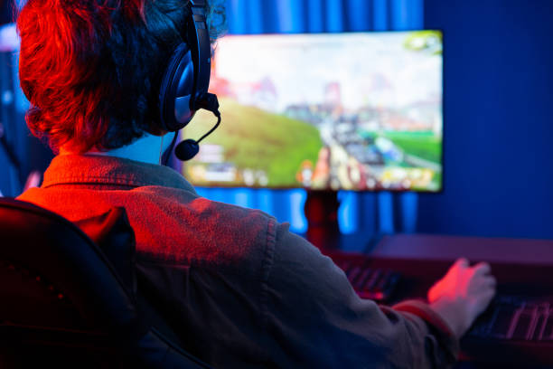 istock Gaming streamer team playing battle game shooting at back side image. Gusher. 2159636116