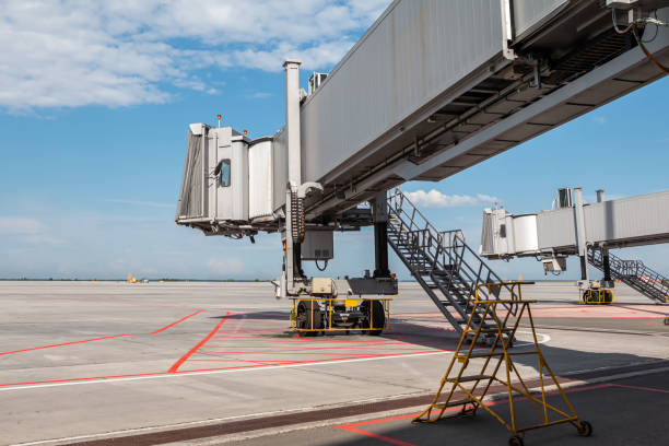 Empty passenger air bridges at airport apron