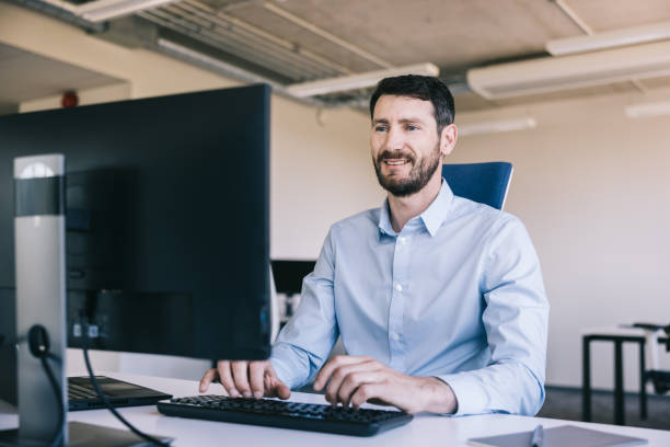 istock Mid adult man working at the office 2159639574