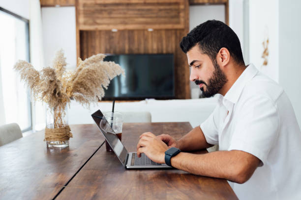 Saudi businessman using laptop on vacation