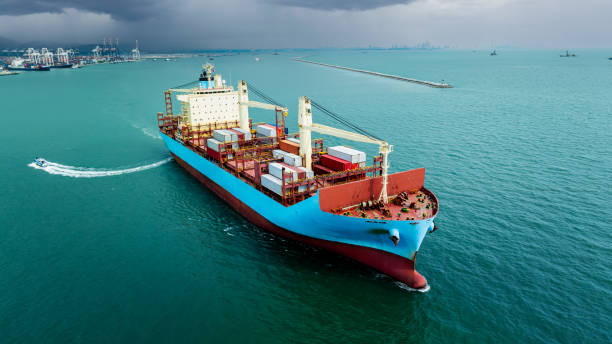 istock cargo container ship sailing  in sea to import export goods and distributing products to dealer and consumers worldwide, by container ship Transport business delivery service, aerial view 2159640630