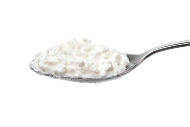 istock Metal spoon with cottage cheese on white background 2159641169