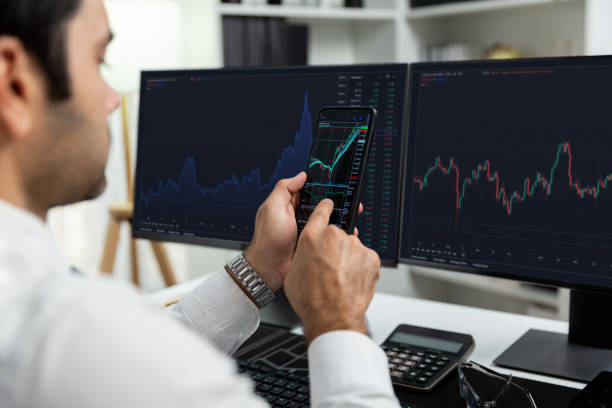 istock Trader businessman searching on smartphone, analyzing in dynamic stock. Surmise. 2159641913