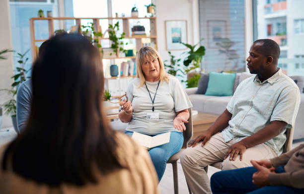 istock A diverse group of people gather in a relaxed environment to participate in a support group session. The setting is cozy with natural light and plants, fostering an atmosphere of openness and trust. 2159641914