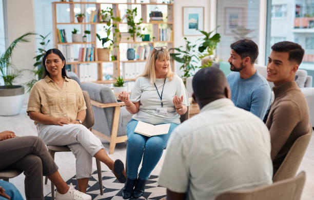 Diverse group of people attending a support group. Participants are sharing and listening, showing community and understanding in a cozy environment. Concepts of mental health, community support, and inclusiveness.