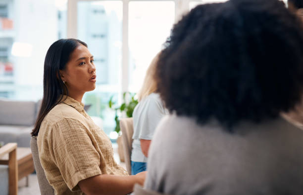 A diverse group of individuals participating in a support group session. The image captures the expressions and interactions within the group, highlighting the importance of community, empathy, and emotional support.