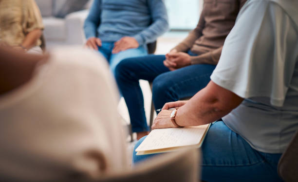 istock A diverse group of individuals attends a support group meeting indoors. People are dressed in casual attire, sharing and listening attentively. The focus is on unity, support, and personal growth in a comfortable setting. 2159641925